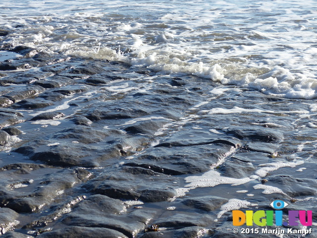 FZ011805 Small waves over rocks on Llantwit Major beach